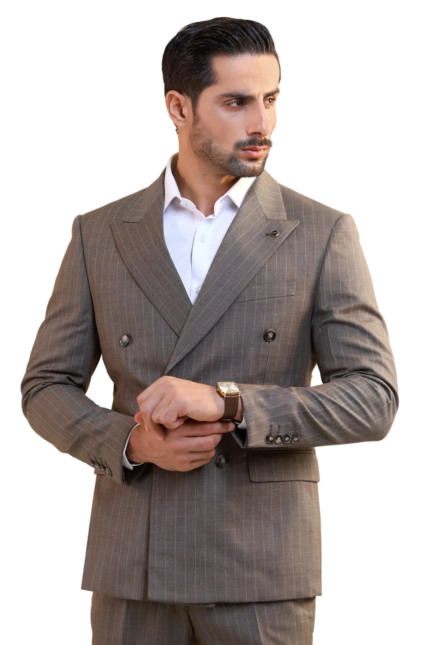 A man wearing a brown double-breasted pinstripe suit with a white dress shirt, standing against a light gray background.